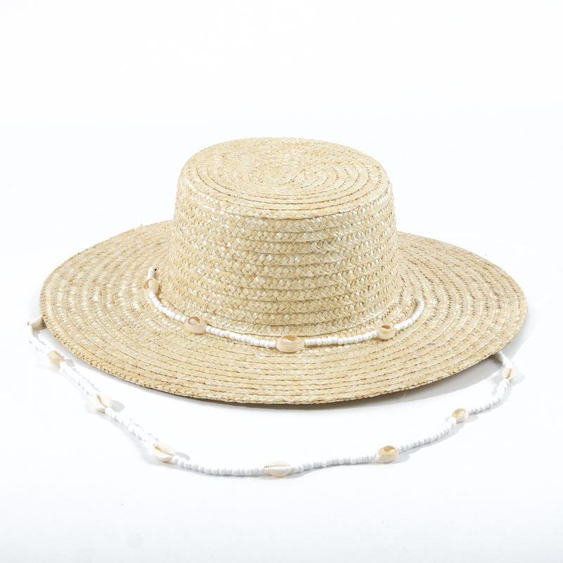 A Large Eaves Straw Hat with a Concave Top for Summer, Featuring a Streamer, Designed for Sun Protection at European And American Beaches, Also Known As a Russian Straw Hat