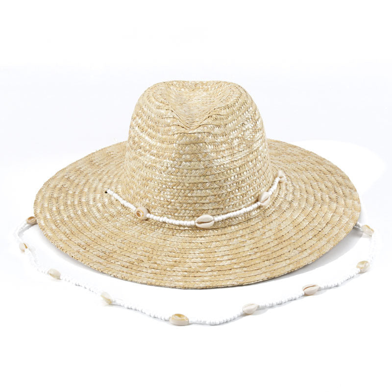 A Large Eaves Straw Hat with a Concave Top for Summer, Featuring a Streamer, Designed for Sun Protection at European And American Beaches, Also Known As a Russian Straw Hat